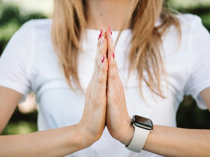 Close up of hands in prayer position during yoga.